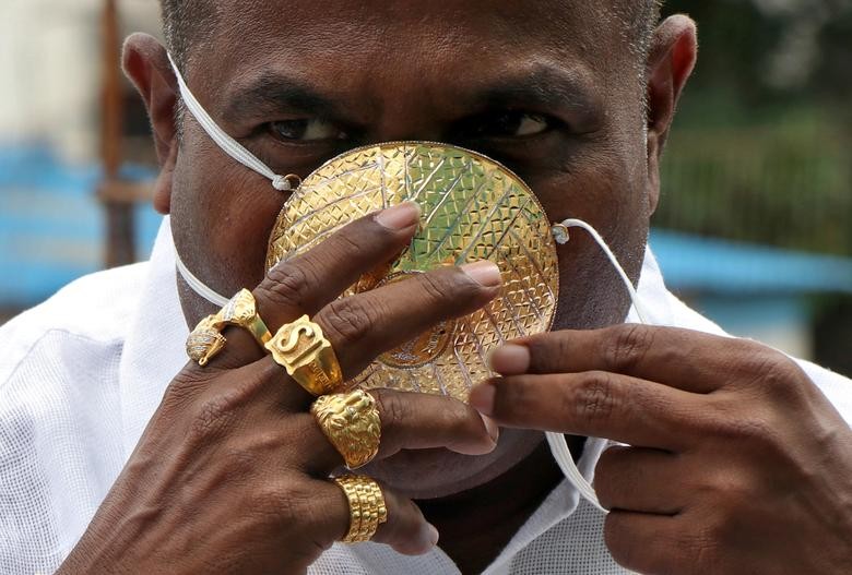 Shankar Kurhade (48), wears his face mask made out of gold as he poses for a photograph amidst the spread of the coronavirus disease (COVID-19) in Pune, India, July 4, 2020. Kurhade claims the mask weighs 50 grams and costs around $3870. REUTERS/Stringer
